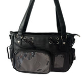 A black faux-leather ita bag with clear vinyl pockets and silver-tone hardware, shown against a plain white background.