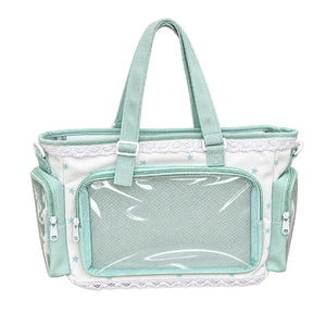Green and white shoulder bag with clear front and side windows to display plushies, keychains and trinkets in a white background