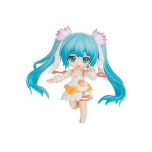 A chibi-style vinyl figure of Hatsune Miku with long bright blue twin-tails, pink flower accessories, and a white outfit with yellow and orange accents, isolated on a black background.
