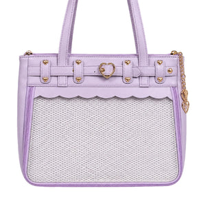 A lavender purple ita shoulder bag with a scalloped clear mesh front pocket, gold-tone heart-shaped hardware, and a gold chain strap on a white background.