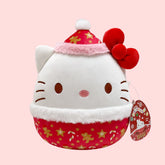 Hello Kitty Plush toy with a red and white design on a pink background