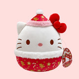 Hello Kitty Plush toy with a red and white design on a pink background