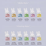 Set of miffy figurines in various colors and styles on a light purple background.