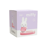 The product packaging box for the Miffy Phone Stand, featuring a light purple and white design with illustrations of the Miffy bunny character and the pink phone stand.