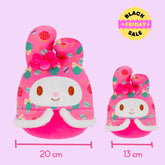 Two pink My melody plush toys with festive patterns and measurements on a pink background