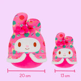Two pink My melody plush toys with festive patterns and measurements on a pink background
