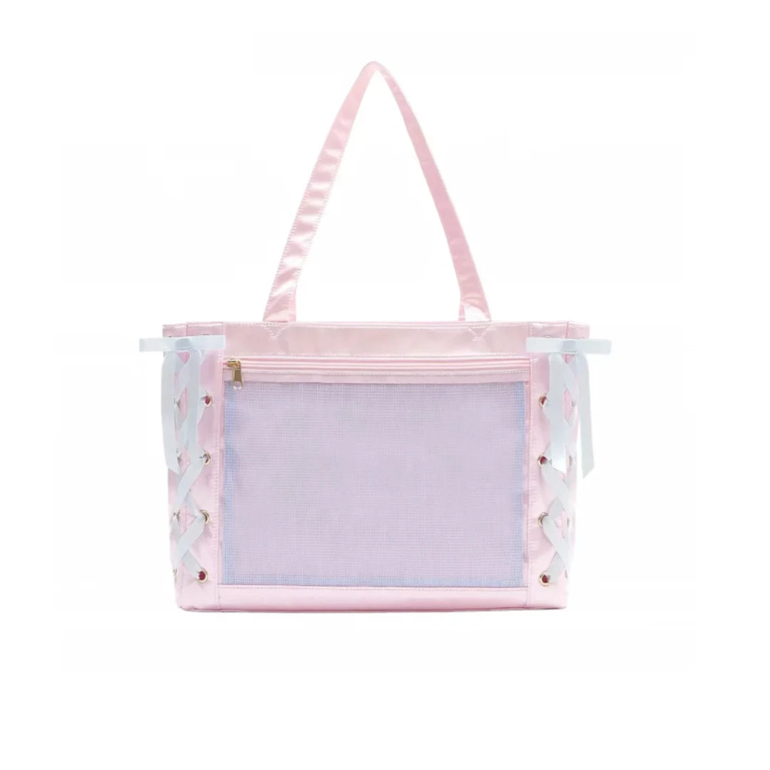 A pastel pink ita bag with a large front mesh window, satin shoulder straps, and decorative white/light blue bows with small pink floral details on the sides.