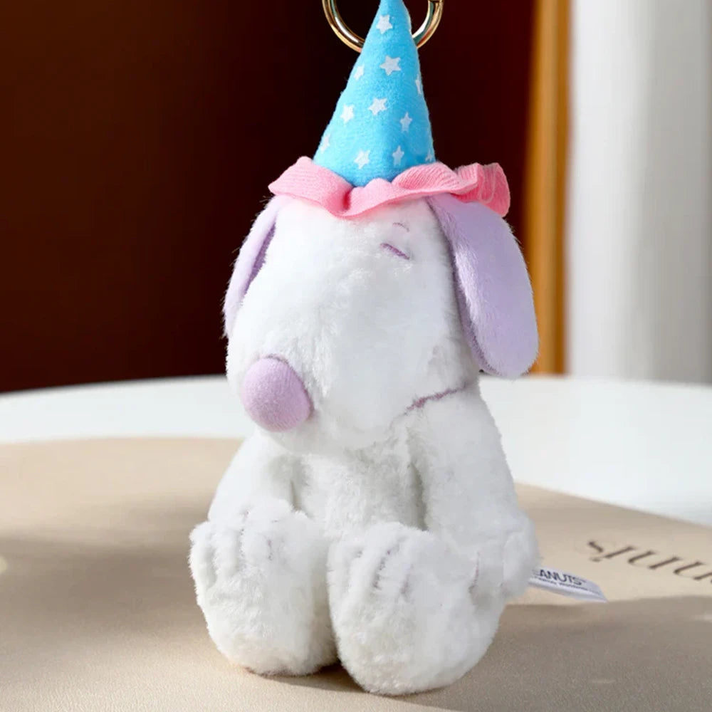 Plush dog toy with a party hat on a neutral background. Snoopy blind box