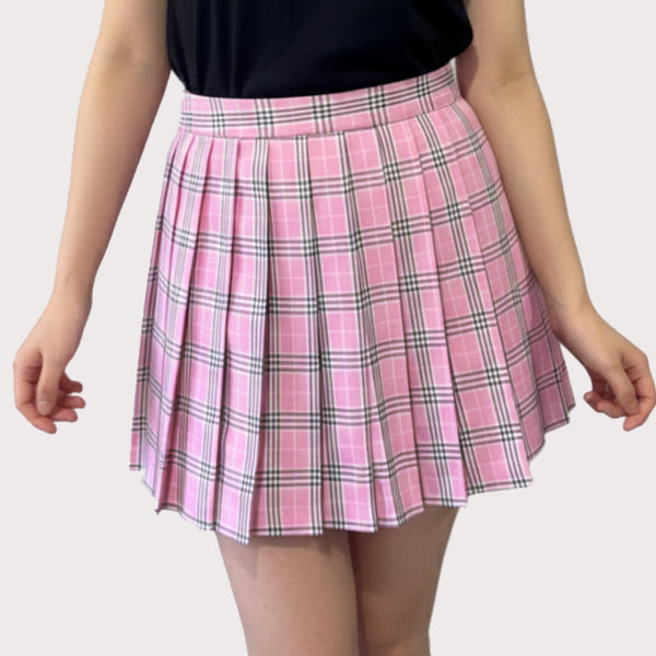 Pink plaid skirt worn by a person on a plain background