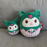 Two green Holiday plush toys of Kuromi  with striped patterns on a gray couch