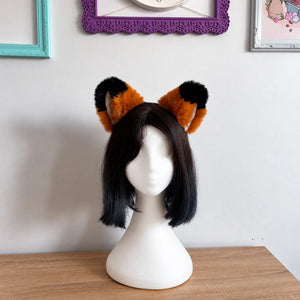 head mannequin wearing cat ears with black tips