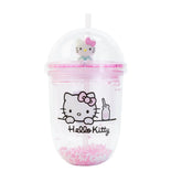 Clear tumbler with pink straw featuring Hello Kitty design on a white background