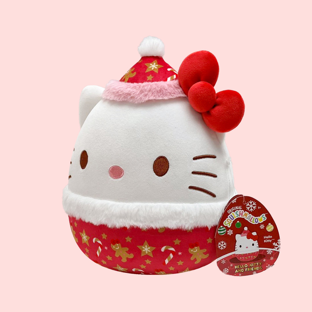 Hello Kitty Plush toy resembling a cat in a Christmas outfit with a pink background