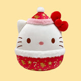 Hello Kitty Squishmallows Plush toy with a Santa hat and red dress on a yellow background