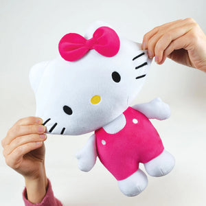 Hello Kitty Plush toy with a pink bow held by hands against a white background.