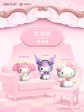 Three cartoon characters on a pink couch with decorative elements. Sanrio blind bag