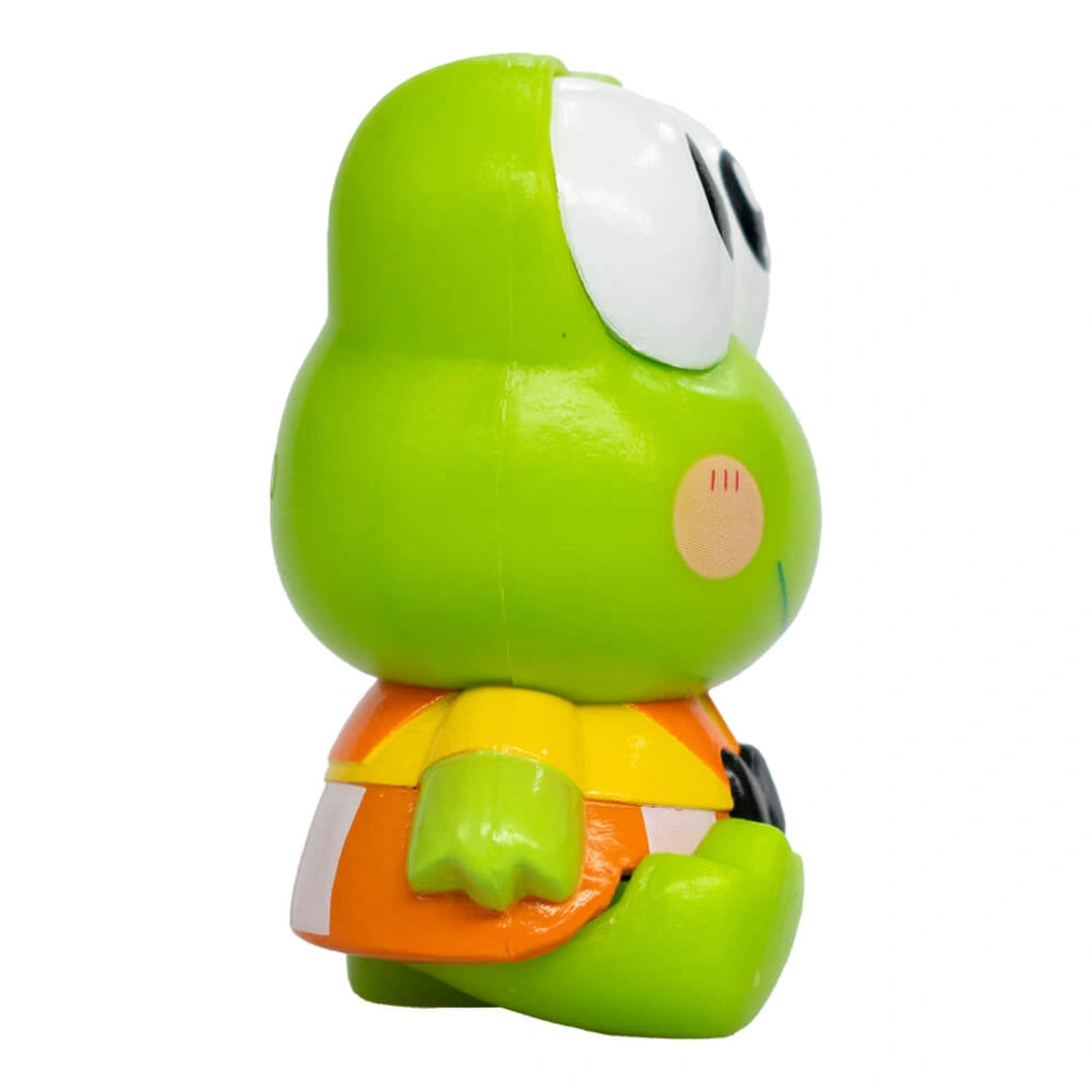 Green cartoon character figurine with a white face on a white background