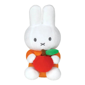 Miffy White plush toy rabbit holding a carrot on a white background