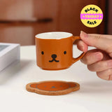 Person holding a brown mug with a bear face design . Miffy blind box