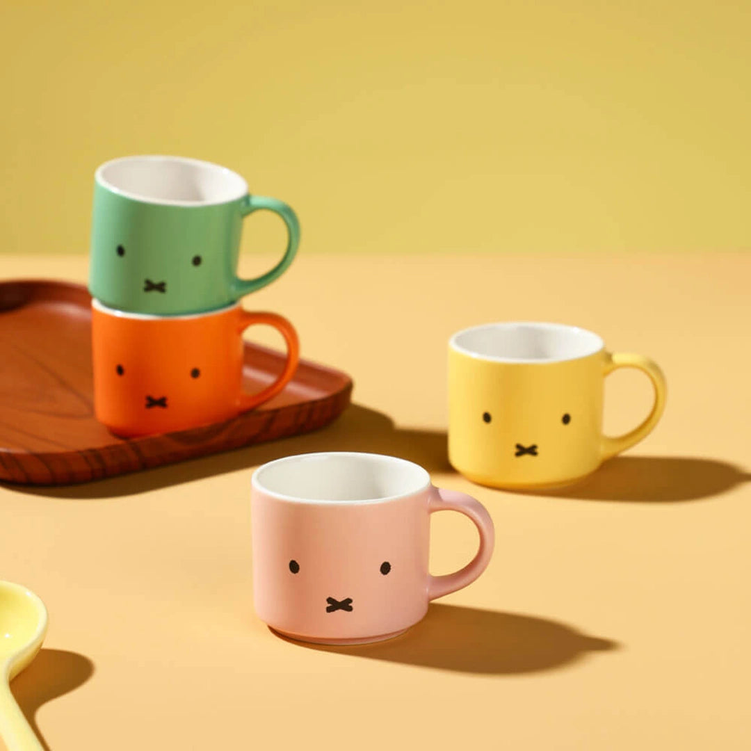 Four colorful mugs with bunny faces