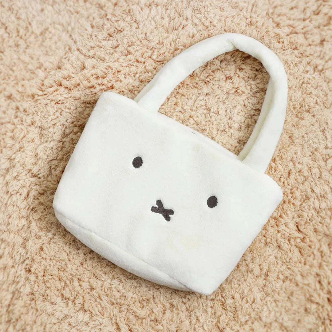 Miffy plush bag on a beige carpet