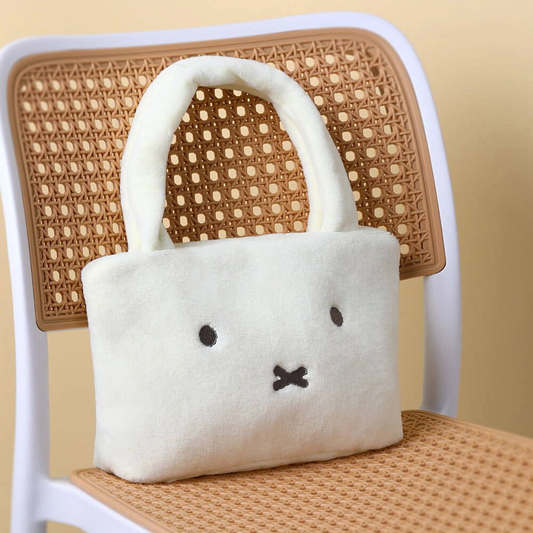 Miffy White plush bag with a face design on a wicker chair
