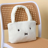 Miffy White plush bag with a face design on a wicker chair