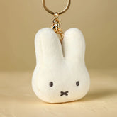 Close-up of Miffy face plush keychain showing soft fabric and embroidered details