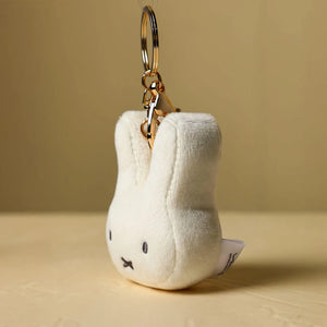 Side view of Miffy face plush keychain with metal keyring attachment