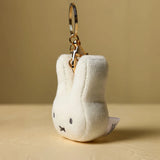 Side view of Miffy face plush keychain with metal keyring attachment