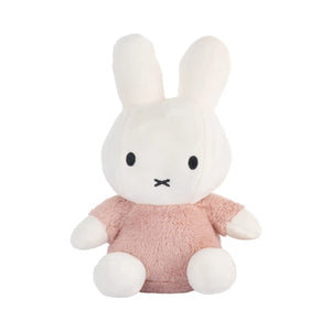 Plush toy rabbit in a pink outfit on a white background