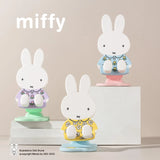 Three Miffy phone stands in different outfits, all part of Miffy blind box collection