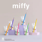 Miffy pencil holders with colorful pencils on a light gray background