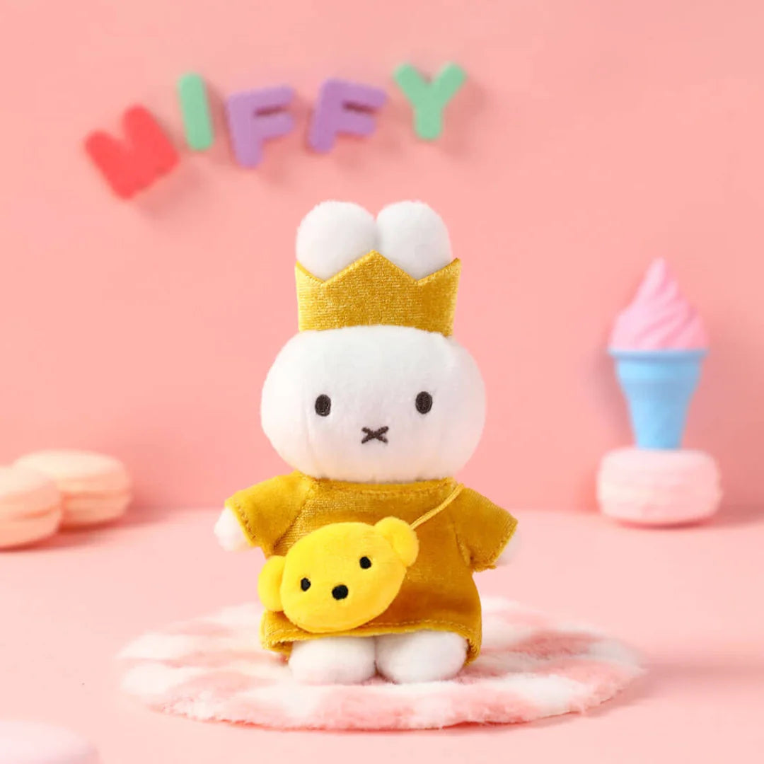 Miffy bag clip with a yellow outfit and crown on a pink background with 'Miffy' text. Miffy blind box Australia