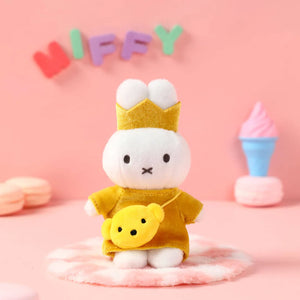 Miffy bag clip with a yellow outfit and crown on a pink background with 'Miffy' text. Miffy blind box Australia