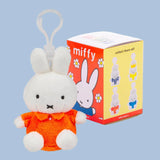 Miffy plush keyring in red/orange dress beside Series 3 box with clip