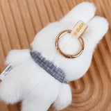White fluffy keychain with a gold ring and visible brand label . Miffy by Vipo