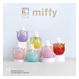Set of colorful miffy figurines in egg-shaped holders on a light blue background with 'miffy' branding.
