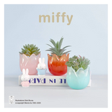 Decorative set with colorful planters and small miffy figurines on a light blue background.