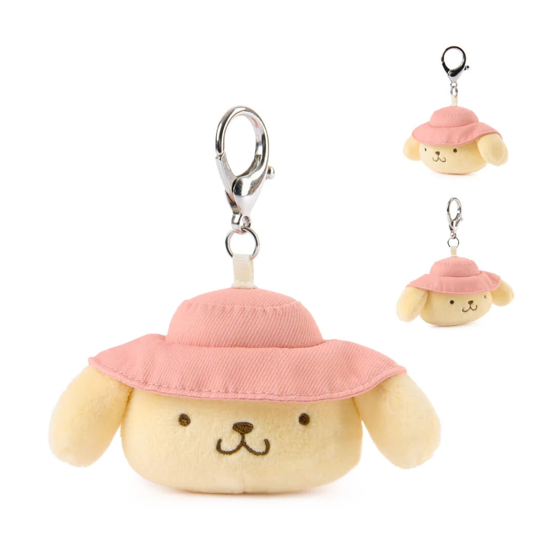 Plush pompompurin dog toy with a pink hat keychain on a white background