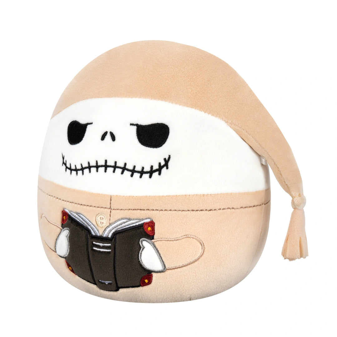 Plush toy with a skull design and a book, resembling a character from 'The Nightmare Before Christmas'.