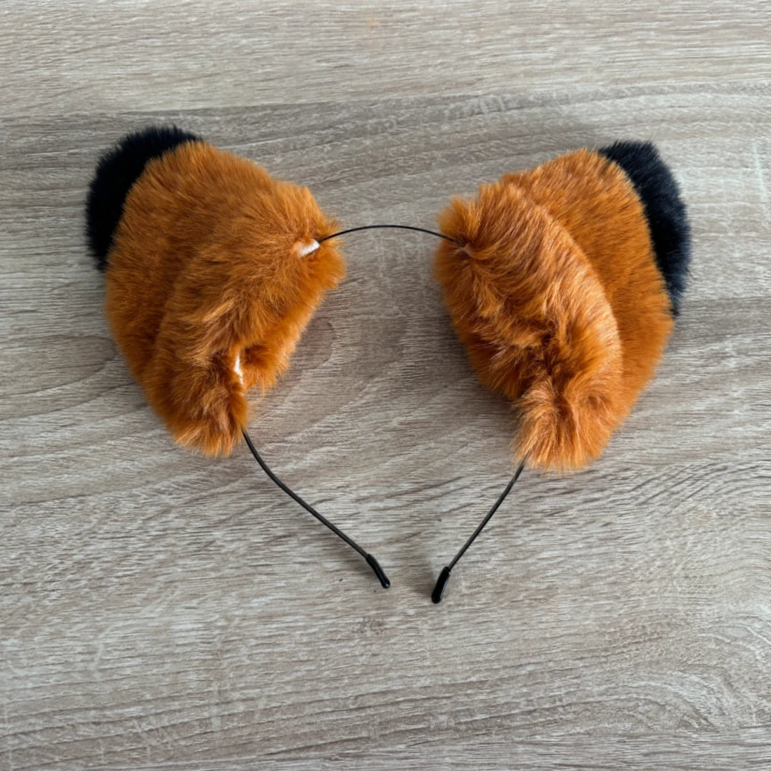 Fox or cat ears with black tips on a headband 