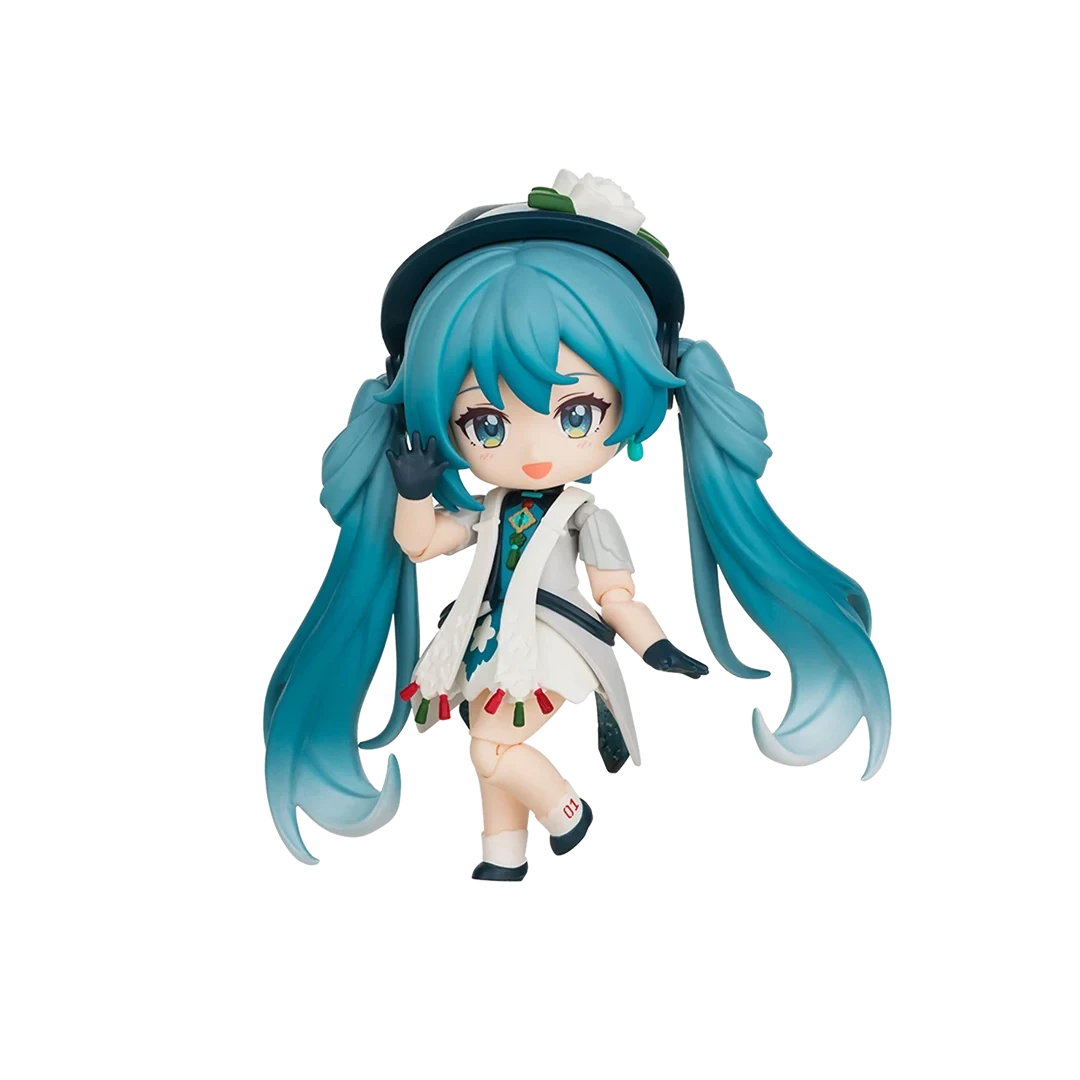A chibi-style vinyl figure of Hatsune Miku with long teal-blue twin tails, wearing a white coat over a multicolored outfit, black gloves, and a dark hat with a white flower, isolated on a black background.