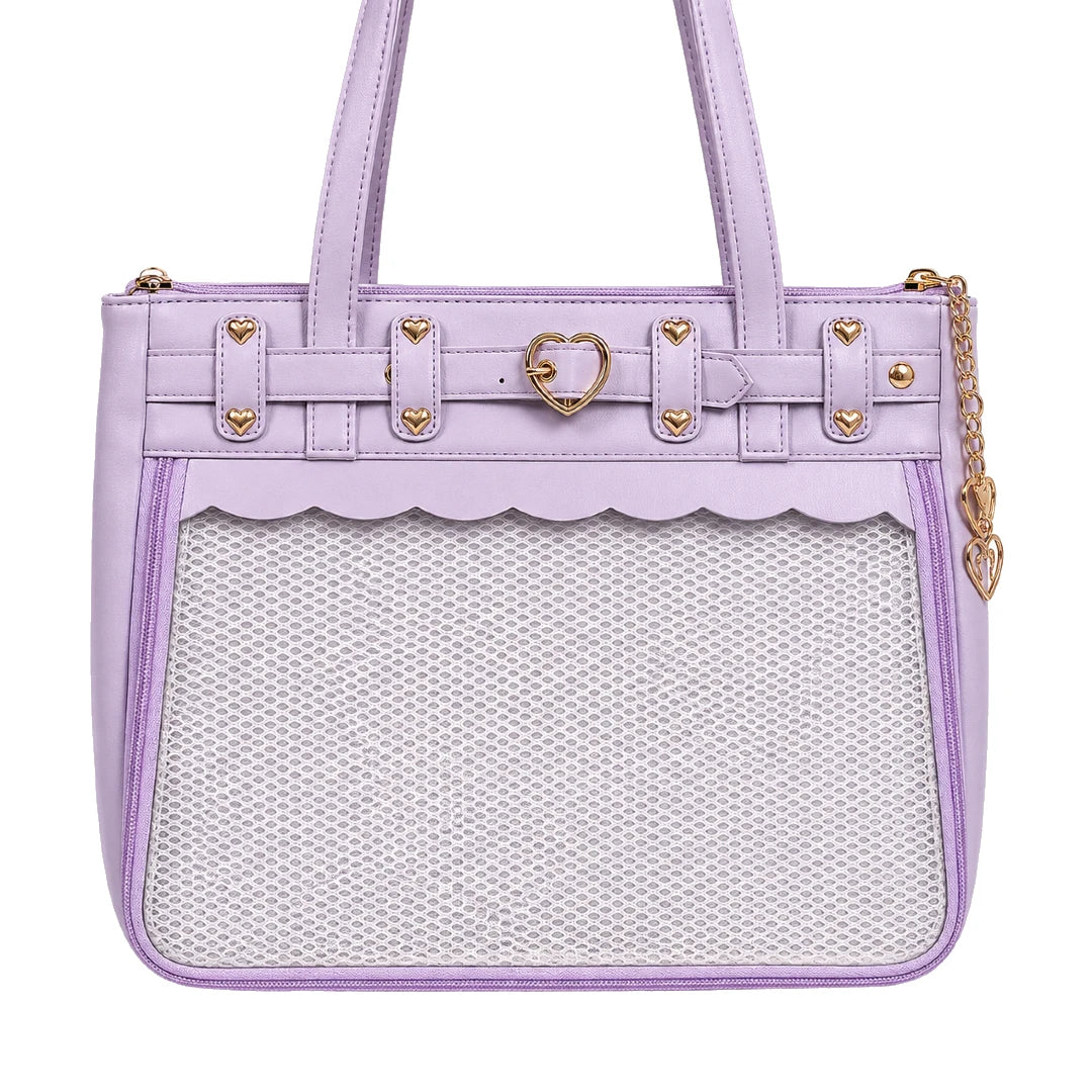 A lavender purple ita shoulder bag with a scalloped clear mesh front pocket, gold-tone heart-shaped hardware, and a gold chain strap on a white background.