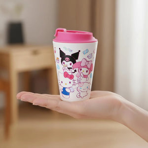 Person holding a Sanrio travel mug with a pink lid. Design includes Kuromi, Hello Kittty, My Melody and Cinnamorroll