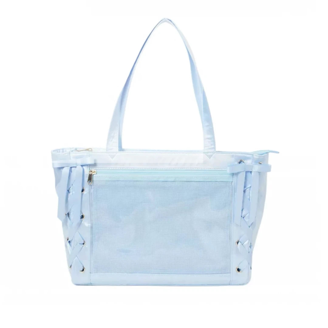 A light blue ita shoulder bag with a front mesh pocket, double shoulder straps, and decorative side lacing with metal grommets, shown against a plain white background.