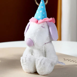 Plush dog toy with a party hat on a neutral background. Snoopy blind box 