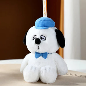Plush toy dog with a blue hat and bow tie on a neutral background