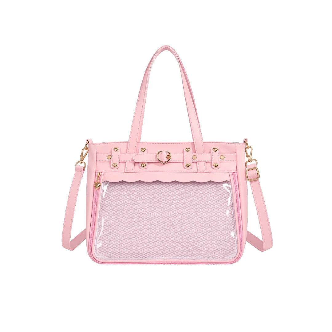A pink structured ita handbag with a clear mesh front pocket, gold-tone hardware, and a matching pink shoulder strap, shown on a plain white background.