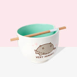 Ceramic bowl with a Pusheen cat design and 'Very Hungry' text, on a pink background.